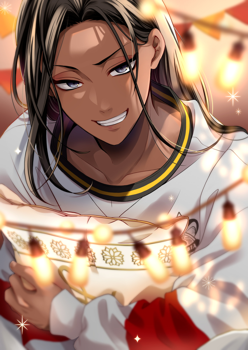 1boy, black_eyes, blurry, blurry_background, blurry_foreground, brown_hair, collarbone, commentary, dark-skinned_male, dark_skin, english_commentary, grin, hair_behind_ear, highres, holding, holding_pillow, jamil_viper, jamil_viper_(cozy_loungewear), kumaru_ayaka, long_hair, long_sleeves, looking_at_viewer, male_focus, parted_bangs, pillow, print_sweater, smile, solo, sparkle, string_of_flags, string_of_light_bulbs, sweater, teeth, twisted_wonderland, upper_body, v-shaped_eyebrows, white_sweater