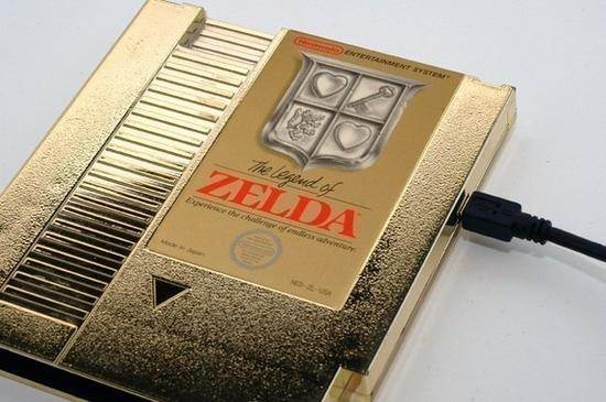 game_console, hard_drive, heart, key, nes, nes_cartridge, nintendo, no_humans, photo_(medium), the_legend_of_zelda, the_legend_of_zelda_(nes), usb