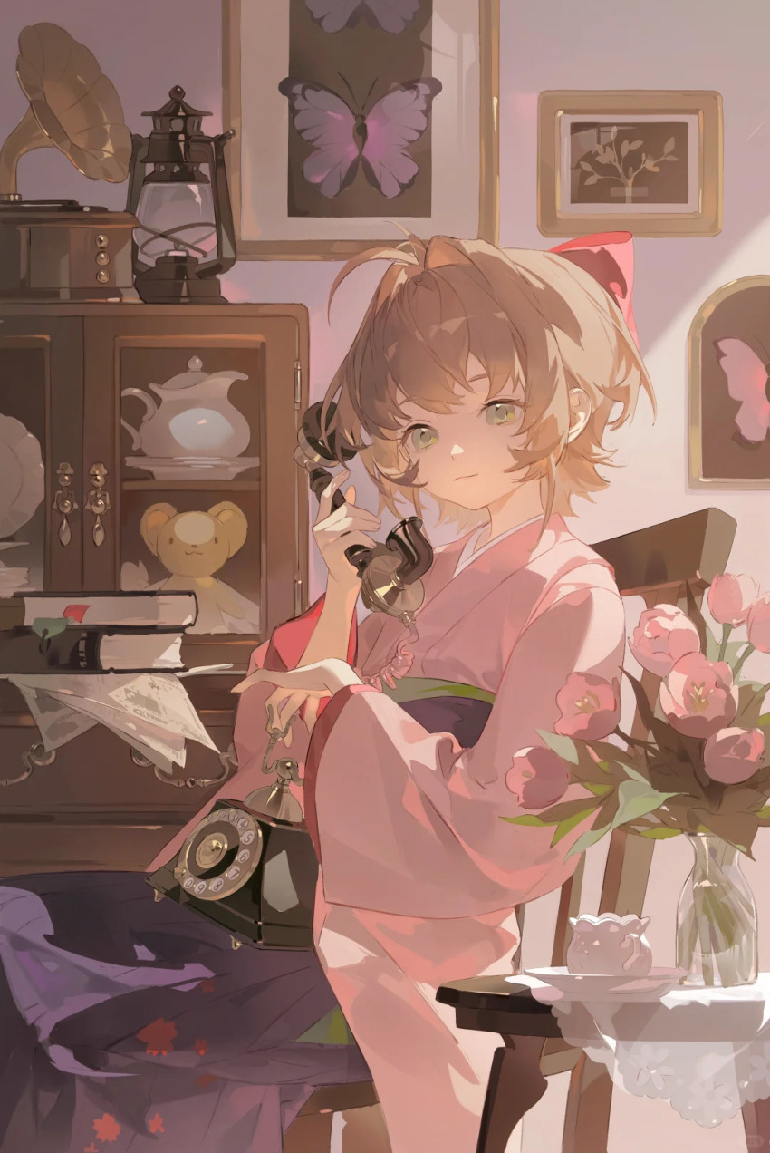 1girl, ahoge, antique_phone, book, book_stack, bookmark, bow, brown_hair, bug, butterfly, cardcaptor_sakura, chair, closed_mouth, cowboy_shot, cup, flower, green_eyes, hair_bow, hair_intakes, hakama, highres, holding, holding_phone, indoors, insect, japanese_clothes, kero_(cardcaptor_sakura), kimono, kinomoto_sakura, lantern, limao_jun, long_sleeves, looking_ahead, on_chair, painting_(object), phone, phonograph, pink_butterfly, pink_flower, pink_kimono, pink_rose, purple_hakama, red_bow, rose, saucer, short_hair, short_kimono, sitting, smile, solo, stuffed_animal, stuffed_toy, table, talking_on_phone, teacup, vase, wide_sleeves