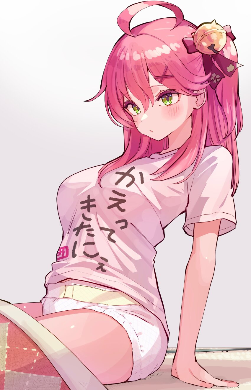 1girl, absurdres, ahoge, alternate_costume, bell, blush, bow, breasts, clothes_writing, commentary_request, diaper, futon, green_eyes, hair_bell, hair_between_eyes, hair_bow, hair_ornament, hairclip, highres, hololive, jingle_bell, large_breasts, long_hair, nanado_shion, pink_bow, pink_hair, pink_shirt, sakura_miko, shirt, short_sleeves, sitting, solo, t-shirt, thighs, virtual_youtuber, white_background