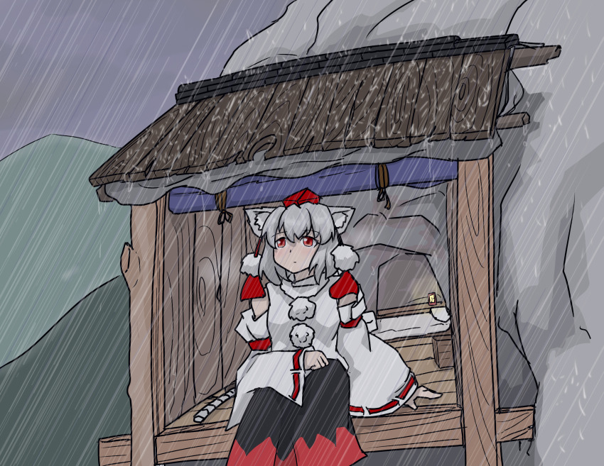 1girl, animal_ear_fluff, animal_ears, arm_on_knee, awning, bench, black_skirt, commentary_request, detached_sleeves, double-parted_bangs, feet_out_of_frame, grey_hair, grey_sky, hat, highres, inubashiri_momiji, killerfurball12, light_frown, long_skirt, long_sleeves, looking_afar, medium_hair, mountain, partial_commentary, pom_pom_(clothes), rain, raised_inner_eyebrows, red_eyes, red_hat, red_ribbon, red_skirt, ribbon, ribbon-trimmed_sleeves, ribbon_trim, shirt, sitting, skirt, sky, solo, staring, tail, tokin_hat, touhou, two-tone_skirt, white_shirt, wide_sleeves, wolf_ears, wolf_girl, wolf_tail