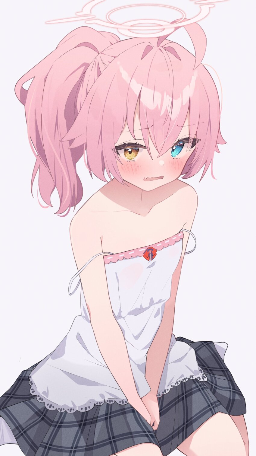 1girl, absurdres, adapted_costume, ahoge, bare_shoulders, between_legs, blue_archive, blue_eyes, blush, camisole, collarbone, commentary, cowboy_shot, embarrassed, fang, flat_chest, grey_skirt, hair_between_eyes, hair_intakes, halo, hand_between_legs, heterochromia, highres, hoshino_(blue_archive), hoshino_(second_year)_(blue_archive), loli, long_hair, miniskirt, official_alternate_hair_length, official_alternate_hairstyle, open_mouth, pink_hair, pink_halo, plaid_clothes, plaid_skirt, ponytail, simple_background, sitting, skin_fang, skirt, solo, sonoji, spaghetti_strap, strap_slip, untranslatable_commentary, upturned_eyes, v_arms, wariza, wavy_mouth, white_background, white_camisole, yellow_eyes