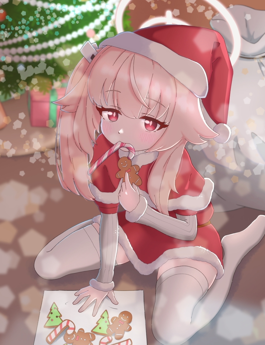 1girl, absurdres, alternate_costume, blue_archive, blush, bright_pupils, capelet, christmas, christmas_tree, closed_mouth, commentary_request, cookie, dress, food, food_in_mouth, full_body, fur-trimmed_capelet, fur-trimmed_dress, fur-trimmed_sleeves, fur_trim, gift_bag, hair_between_eyes, halo, hat, highres, holding, holding_food, indoors, long_hair, looking_at_viewer, natsu_(blue_archive), ning0kuarchive, no_shoes, pink_hair, red_capelet, red_dress, red_eyes, santa_capelet, santa_costume, santa_dress, santa_hat, short_dress, side_ponytail, sidelocks, sitting, sleeves_past_wrists, solo, thighhighs, tsurime, wariza, white_halo, white_pupils, white_thighhighs, zettai_ryouiki