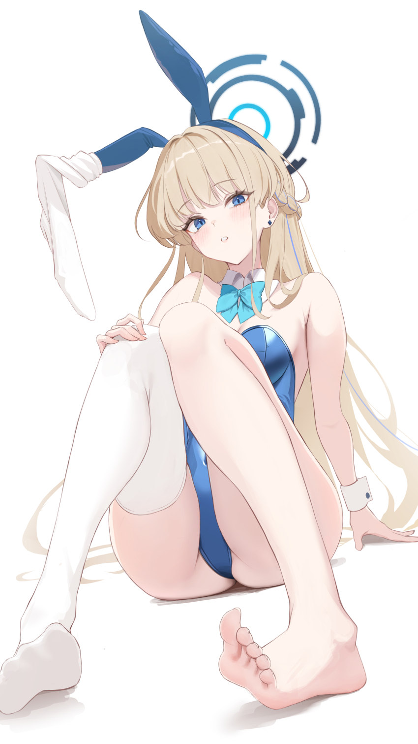 1girl, absurdres, animal_ear_hairband, animal_ears, barefoot, blonde_hair, blue_archive, blue_bow, blue_bowtie, blue_eyes, blue_hairband, blue_halo, blue_leotard, bow, bowtie, braid, breasts, cleavage, detached_collar, earrings, fake_animal_ears, feet, hair_intakes, hairband, half_up_braid, halo, highres, jewelry, kanketsu25, knees_up, leotard, long_hair, looking_at_viewer, medium_breasts, official_alternate_costume, official_alternate_hairstyle, playboy_bunny, rabbit_ear_hairband, rabbit_ears, simple_background, single_thighhigh, sitting, soles, solo, strapless, strapless_leotard, stud_earrings, thighhighs, thighs, toenails, toes, toki_(blue_archive), toki_(bunny)_(blue_archive), white_background, white_thighhighs, white_wrist_cuffs, wrist_cuffs