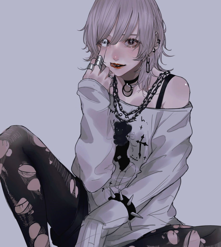 1girl, animal_charm, bare_shoulders, bear_charm, black_choker, black_eyes, black_pantyhose, black_shorts, bra_strap, bracelet, bracelet_over_sleeve, chain, chain_necklace, choker, commentary_request, cross, ear_piercing, eyelashes, feet_out_of_frame, grey_background, grey_hair, hair_between_eyes, highres, jewelry, knee_up, latin_cross, licking_lips, long_sleeves, looking_at_viewer, mano_aaa, medium_hair, middle_finger, mole, mole_under_eye, nail_art, nail_polish, necklace, off-shoulder_shirt, off_shoulder, original, pantyhose, paperclip_earrings, parted_lips, piercing, print_shirt, red_lips, shirt, shorts, simple_background, single_sleeve_past_fingers, sitting, sleeves_past_wrists, solo, spiked_bracelet, spikes, tongue, tongue_out, torn_clothes, torn_pantyhose, white_nails, white_shirt, wolf_cut