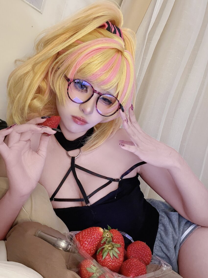 1girl, absurdres, adjusting_eyewear, armpit_crease, black_camisole, black_nails, blonde_hair, blue_eyes, camisole, choker, cosplay, cosplay_photo, food, fruit, grey_shorts, gyaru, hair_ornament, hair_scrunchie, half-closed_eye, highres, kikuro_815, kotoka_torahime, kotoka_torahime_(3rd_costume), lying, multicolored_nails, nail_polish, nijisanji, nijisanji_en, o-ring, o-ring_choker, o-ring_top, official_alternate_costume, official_alternate_hairstyle, on_side, photo_(medium), pink_lips, pink_nails, pink_streaks, round_eyewear, scrunchie, shorts, single_off_shoulder, spaghetti_strap, strap, strawberry, virtual_youtuber