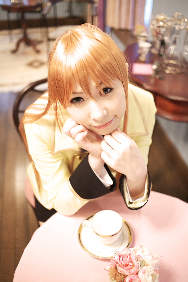 1girl, blazer, blue_eyes, chippi, code_geass, color_contacts, cosplay, east_asian, female_focus, highres, jacket, long_hair, looking_at_viewer, orange_hair, photo_(medium), school_uniform, shirley_fenette, shirley_fenette_(cosplay), sitting, solo, tea_shop