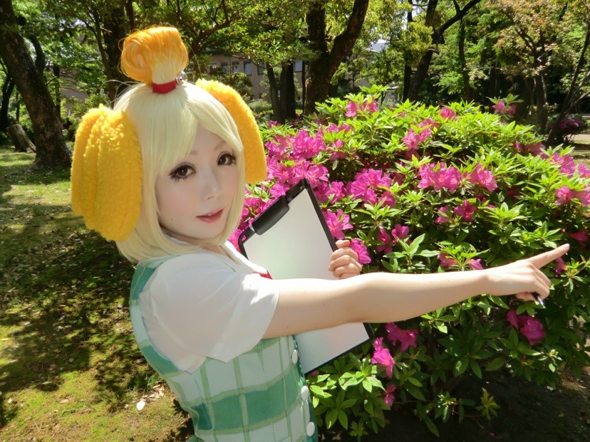 1girl, animal_crossing, animal_ears, bell, blonde_hair, brown_eyes, clipboard, cosplay, dog_ears, east_asian, f_maleen, isabelle_(animal_crossing), isabelle_(animal_crossing)_(cosplay), nintendo, open_mouth, personification, photo_(medium), pointing