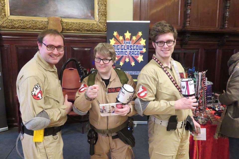 3boys, antimatter_weapon, backpack, bag, chair, directed-energy_weapon, energy_gun, energy_weapon, ghostbusters, ghostbusters_of_scotland, male_focus, multiple_boys, particle-beam_weapon, particle_thrower, photo_(medium), proton_pack, weapon
