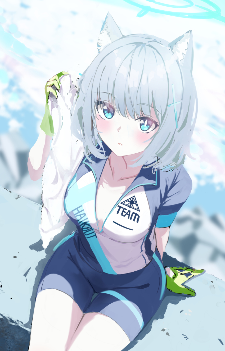 1girl, animal_ear_fluff, animal_ears, biker_clothes, blue_archive, blue_eyes, blurry, blurry_background, blush, breasts, bright_pupils, cat_ears, cleavage, clothes_writing, cross_hair_ornament, day, depth_of_field, from_above, gloves, green_gloves, hair_ornament, halo, highres, holding, holding_towel, looking_at_viewer, looking_up, medium_breasts, mismatched_pupils, moko_(alice), outdoors, parted_lips, shiroko_(blue_archive), shiroko_(cycling)_(blue_archive), short_sleeves, sitting, solo, thigh_gap, towel