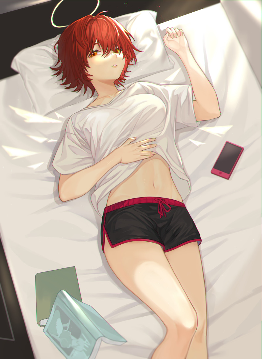 1girl, absurdres, arknights, bed, black_shorts, book, cellphone, dolphin_shorts, exusiai_(arknights), eza_(yowza), feet_out_of_frame, halo, hand_up, highres, looking_at_viewer, lying, midriff, navel, on_back, orange_eyes, parted_lips, phone, red_hair, shirt, short_hair, short_sleeves, shorts, smartphone, solo, stomach, thighs, white_shirt
