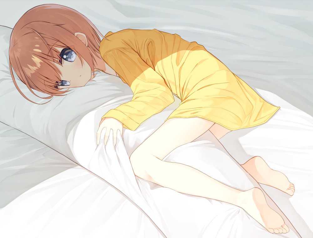 1girl, barefoot, bed_sheet, blush, body_pillow, brown_hair, closed_mouth, commentary_request, grey_hair, long_sleeves, lucena_winter, lying, hugging_object, on_side, original, pillow, pillow_hug, shirt, sleeves_past_wrists, soles, solo, yellow_shirt, yuuhagi_(amaretto-no-natsu)