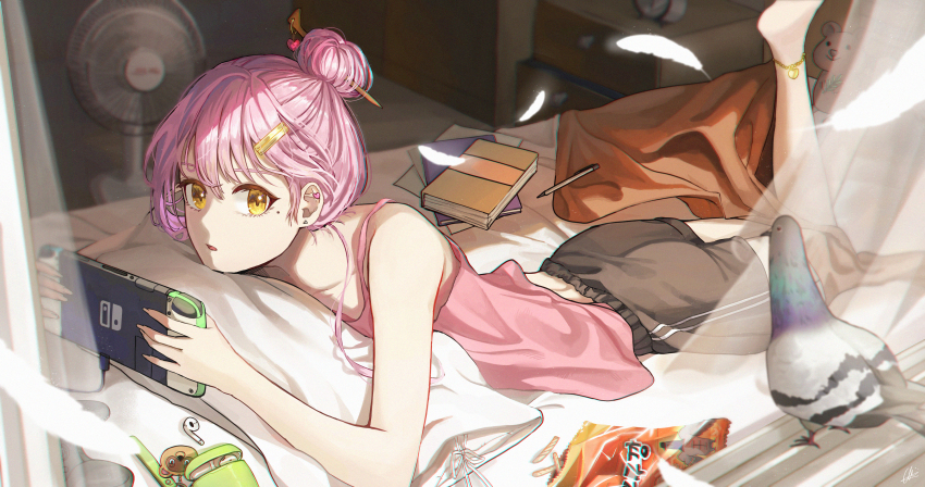 1girl, absurdres, alarm_clock, anklet, bag_charm, barefoot, bird, black_shorts, blurry, blurry_background, book, camisole, charm_(object), cherry59599, clock, drawer, earbuds, earphones, earrings, electric_fan, hair_bun, hair_ornament, hair_stick, hairclip, handheld_game_console, heart, highres, holding, holding_handheld_game_console, jewelry, lying, mole, mole_under_eye, nintendo_switch, on_stomach, original, pen, pigeon, pink_camisole, pink_hair, scenery, shorts, snack, stud_earrings, stuffed_animal, stuffed_toy, teddy_bear, window, yellow_eyes