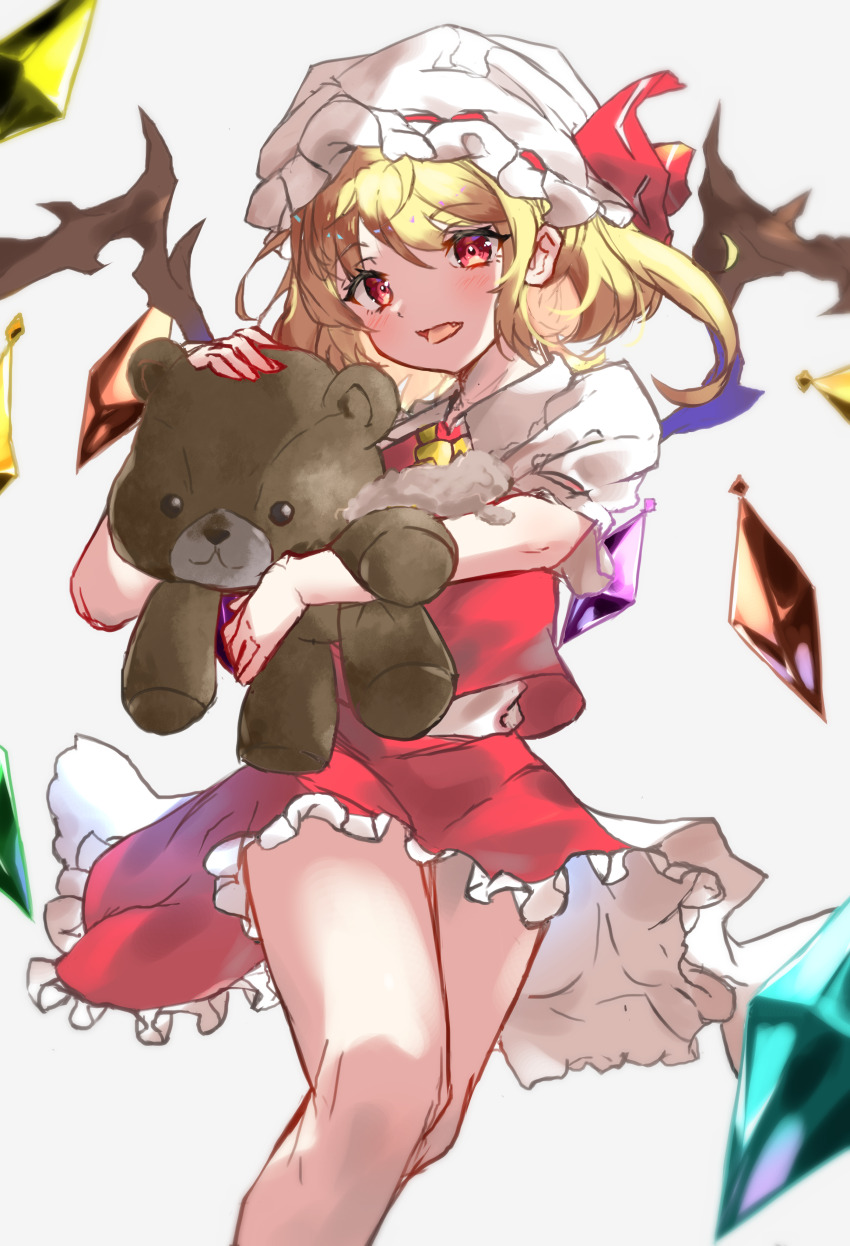 1girl, absurdres, blonde_hair, collared_shirt, crystal, fang, feet_out_of_frame, flandre_scarlet, frilled_skirt, frills, hair_between_eyes, hat, hat_ribbon, highres, holding, holding_stuffed_toy, medium_hair, mob_cap, multicolored_wings, open_mouth, puffy_short_sleeves, puffy_sleeves, red_eyes, red_ribbon, red_skirt, red_vest, ribbon, ribbon-trimmed_headwear, ribbon_trim, shirt, short_sleeves, side_ponytail, simple_background, skirt, skirt_set, solo, sorusugar0141, stuffed_animal, stuffed_toy, teddy_bear, touhou, vest, white_background, white_hat, white_shirt, wings