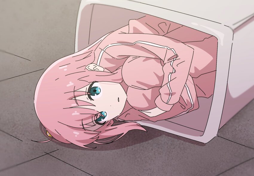 1girl, blue_eyes, blush, bocchi_the_rock!, floor, fujimiz, gotoh_hitori, hair_between_eyes, highres, hugging_own_legs, indoors, jacket, long_hair, long_sleeves, lying, on_side, one_side_up, open_mouth, pants, pink_hair, pink_jacket, pink_pants, solo, track_jacket, track_pants, trash_can