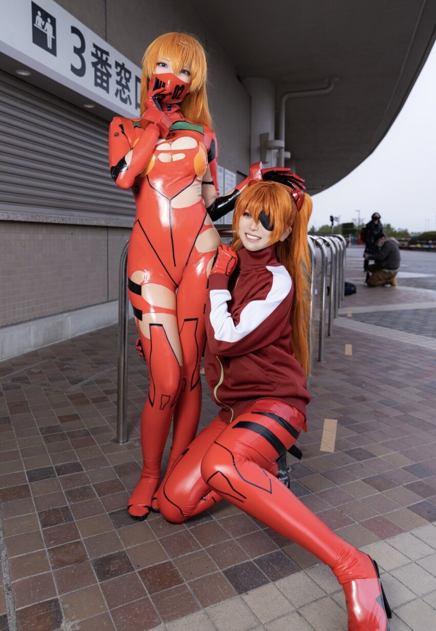 2girls, blue_eyes, bodysuit, bodysuit_under_clothes, breasts, brown_hair, cosplay, cosplay_photo, east_asian, evangelion:_3.0+1.0_thrice_upon_a_time, evangelion:_3.0_you_can_(not)_redo, eyepatch, full_body, glico_happy, hair_down, hand_on_own_hip, highres, jacket, japanese_(nationality), kneeling, long_hair, long_sleeves, looking_at_viewer, mask, mecha_pilot_suit, medium_breasts, mouth_mask, multicolored_bodysuit, multiple_girls, neo.omochi, neon_genesis_evangelion, photo_(medium), plugsuit_(evangelion), rebuild_of_evangelion, red_bodysuit, shiny_clothes, sky, smile, souryuu_asuka_langley, souryuu_asuka_langley_(cosplay), standing, torn_bodysuit, torn_clothes, very_long_hair