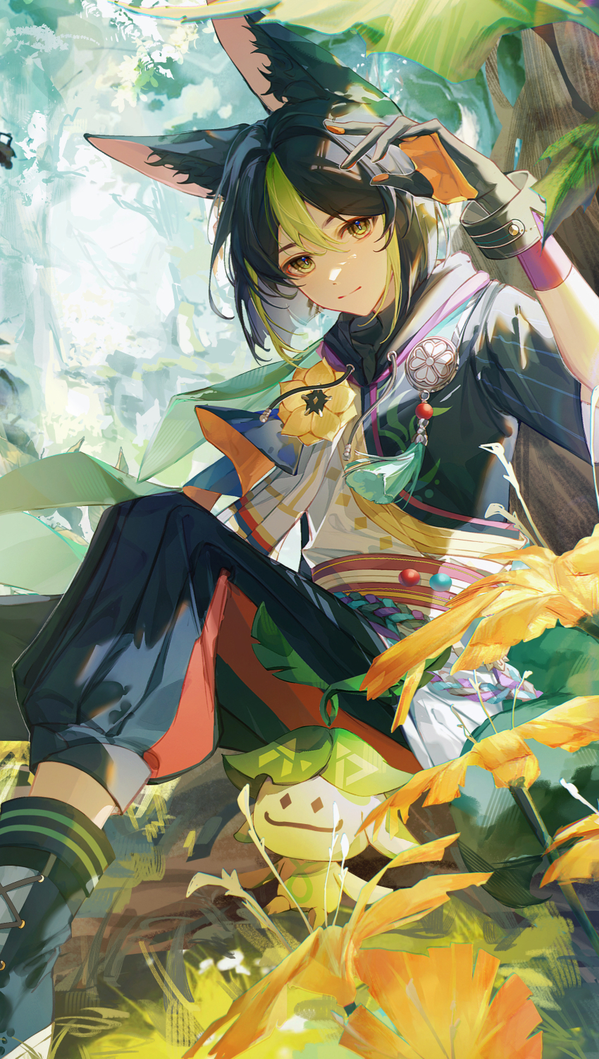 1boy, absurdres, animal_ear_fluff, animal_ears, aranara_(genshin_impact), black_gloves, black_hair, black_pants, black_shirt, blunt_ends, blurry, blurry_background, blush, bolin_jiazi_gu, brown_gloves, cape, capri_pants, closed_mouth, commentary_request, day, drawstring, earrings, flower, forest, fox_boy, fox_ears, genshin_impact, gloves, green_cape, green_eyes, green_hair, hair_between_eyes, hand_up, highres, hood, hood_down, hoodie, jewelry, leaf, looking_at_viewer, male_focus, medal, multicolored_clothes, multicolored_hair, nature, outdoors, pants, plant, purple_sash, rope, sash, shirt, short_hair, short_sleeves, sidelocks, single_earring, sitting, smile, tassel, tighnari_(genshin_impact), tree, turtleneck, two-tone_gloves, two-tone_hair, wrist_cuffs, yellow_flower