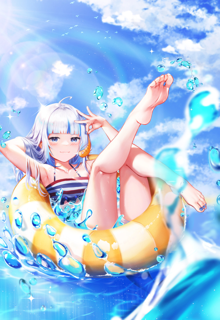 1girl, ahoge, arm_up, armpits, barefoot, bikini, blue_eyes, blue_nails, blue_sky, blunt_bangs, blurry, blurry_foreground, blush, closed_mouth, cloud, cloudy_sky, collarbone, commentary, day, ebi-chan_(gawr_gura), english_commentary, feet, fins, fish_tail, flat_chest, frills, gawr_gura, grey_hair, hand_up, highres, holding, hololive, hololive_english, innertube, knee_up, koukie, leg_up, legs, lens_flare, long_hair, looking_at_viewer, multicolored_hair, nail_polish, outdoors, shark_girl, shark_tail, shiny_skin, shrimp, sky, smile, soles, solo, streaked_hair, striped_bikini, striped_clothes, swim_ring, swimsuit, tail, toenail_polish, toenails, toes, virtual_youtuber, water