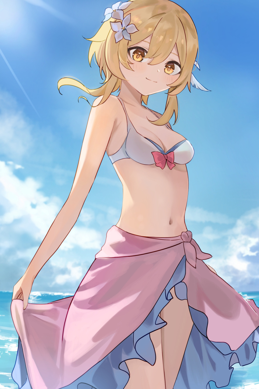 bikini, blonde_hair, blue_sky, blush, bow, bow_bikini, breasts, cleavage, clothes_lift, cloud, feather_hair_ornament, feathers, flower, frilled_sarong, genshin_impact, hair_between_eyes, hair_flower, hair_ornament, highres, light_rays, light_smile, looking_at_viewer, lumine_(genshin_impact), medium_breasts, midriff, navel, ocean, outdoors, pink_sarong, ponzu_pon9, sarong, sarong_lift, short_hair_with_long_locks, sidelocks, sky, stomach, sunbeam, sunlight, swimsuit, white_bikini, white_flower, yellow_eyes