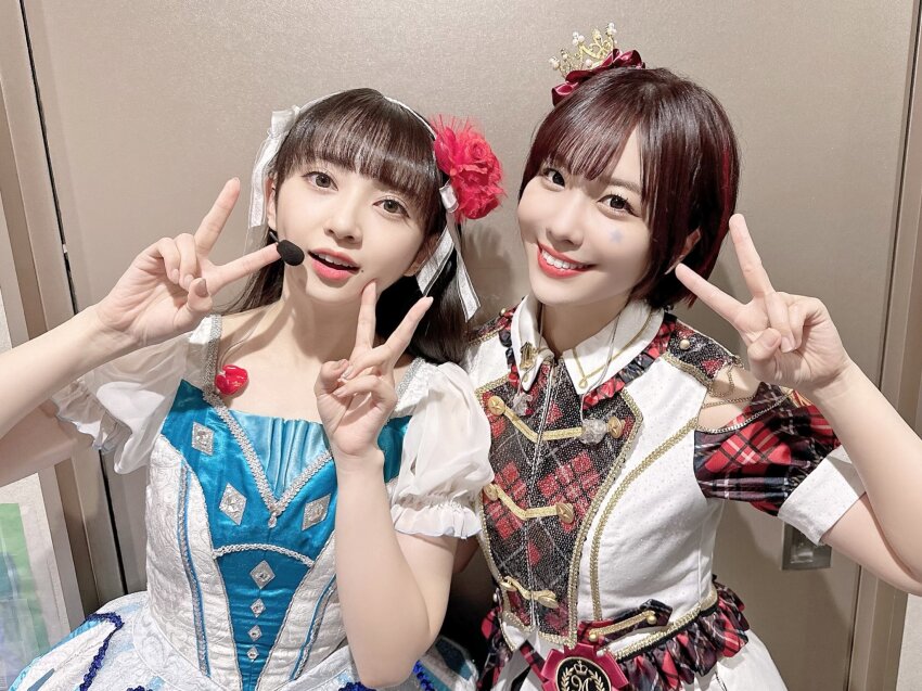 2girls, costume, highres, komiya_arisa, looking_at_viewer, multiple_girls, photo_(medium), simple_background