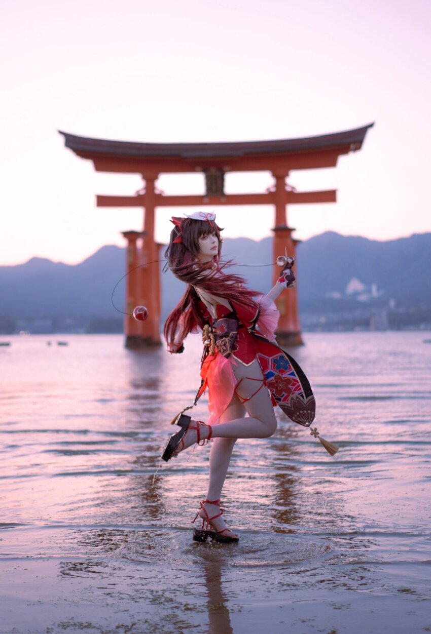 1girl, blurry, blurry_background, brown_hair, closed_mouth, cosplay_photo, detached_sleeves, dress, facial_mark, floating_hair, fox_mask, full_body, gradient_hair, highres, hiroshima, honkai:_star_rail, honkai_(series), itsukushima_shrine, kendama, long_hair, looking_at_viewer, mask, mask_on_head, multicolored_hair, okobo, outdoors, photo_(medium), platform_sandals, red_dress, red_hair, sandals, short_dress, solo, sparkle_(honkai:_star_rail), standing, standing_on_one_leg, thigh_strap, torii, twintails, wading, x_iaohaaaaa
