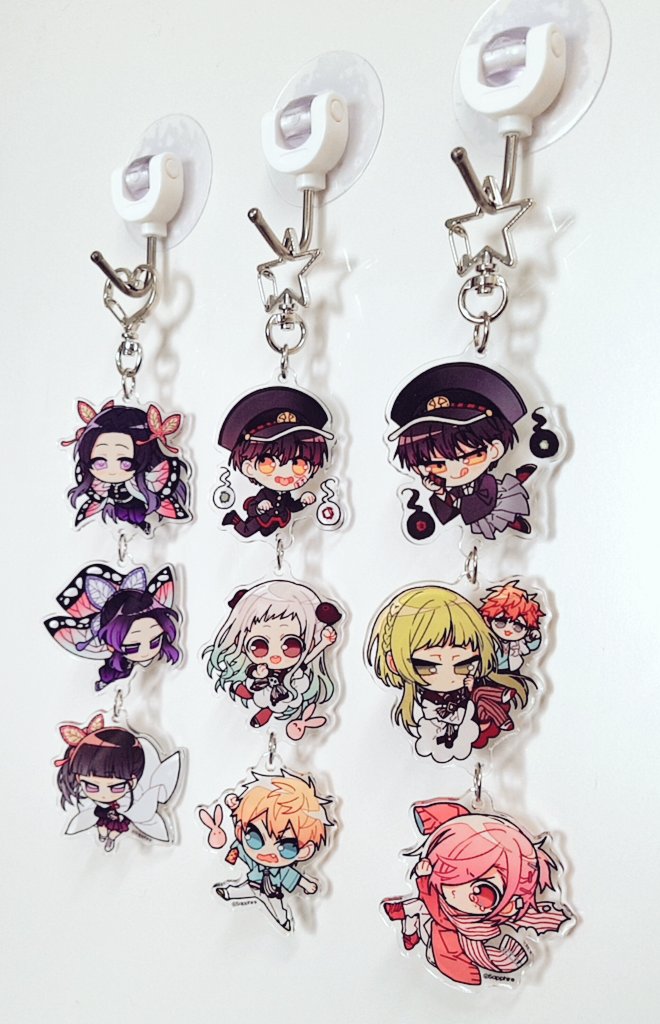 5boys, 5girls, :q, black_hair, butterfly_hair_ornament, charm_(object), chibi, closed_mouth, demon_slayer_uniform, hair_ornament, hanako_(jibaku_shounen_hanako-kun), hyuuga_natsuhiko, jibaku_shounen_hanako-kun, kimetsu_no_yaiba, kochou_kanae, kochou_shinobu, long_hair, looking_at_viewer, minamoto_kou, mitsuba_sousuke, mokke_(jibaku_shounen_hanako-kun), multiple_boys, multiple_girls, nanamine_sakura, open_mouth, parted_bangs, photo_(medium), pink_background, pink_eyes, pink_hair, purple_eyes, purple_hair, rabbit, sapphire_(nine), scarf, sidelocks, simple_background, single_sleeve_past_fingers, smile, striped_clothes, striped_scarf, tongue, tongue_out, tsuyuri_kanao, very_long_hair, white_background, white_hair, yashiro_nene, yellow_eyes, yugi_tsukasa