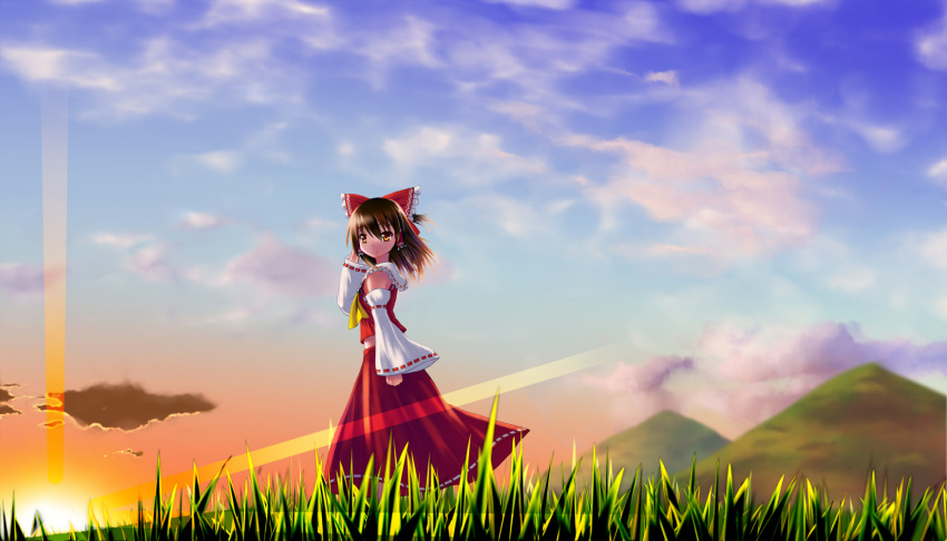 1girl, ascot, bow, brown_hair, clenched_hand, clouds, detached_sleeves, grass, hair_bow, hair_tubes, hakurei_reimu, hand_behind_head, highres, lens_flare, looking_at_viewer, midriff, mountain, noronosuke, orange_eyes, short_hair, skirt, skirt_set, sky, solo, sunset, touhou