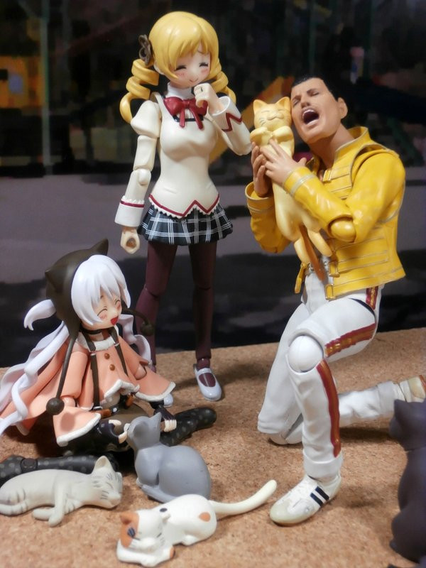 1boy, 2girls, blonde_hair, cat, facial_hair, figure, freddie_mercury, long_hair, mahou_shoujo_madoka_magica, mahou_shoujo_madoka_magica_movie, momoe_nagisa, multiple_girls, mustache, photo, smile, tomoe_mami, twintails, white_hair