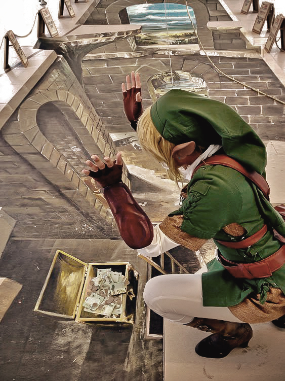 belt, blonde_hair, boots, chalk, chobitsg, cosplay, gauntlets, hat, link, photo, pointy_ears, solo, squatting, the_legend_of_zelda