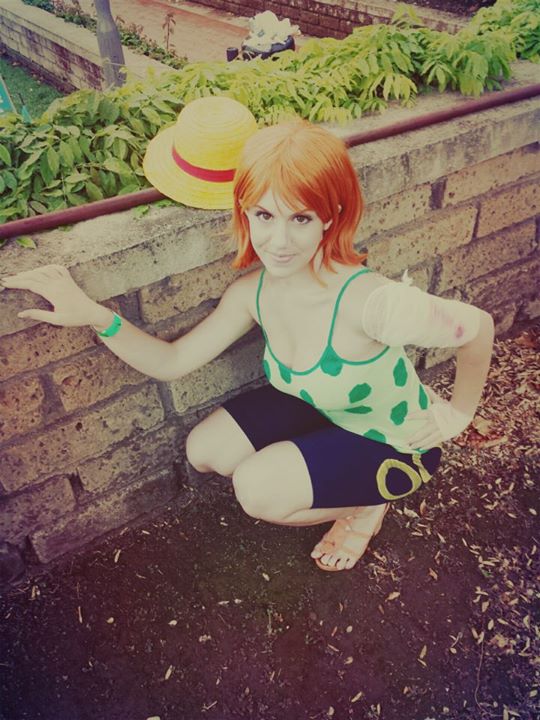 1girl, camisole, cosplay, hat, nami_(one_piece), nami_(one_piece)_(cosplay), one_piece, orange_hair