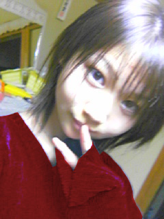 1girl, brown_eyes, brown_hair, cosplay, finger_to_mouth, indoors, looking_at_viewer, lowres, nevada-tan, nevada-tan_(cosplay), photo, portrait, qvga, short_hair, smile, solo, v