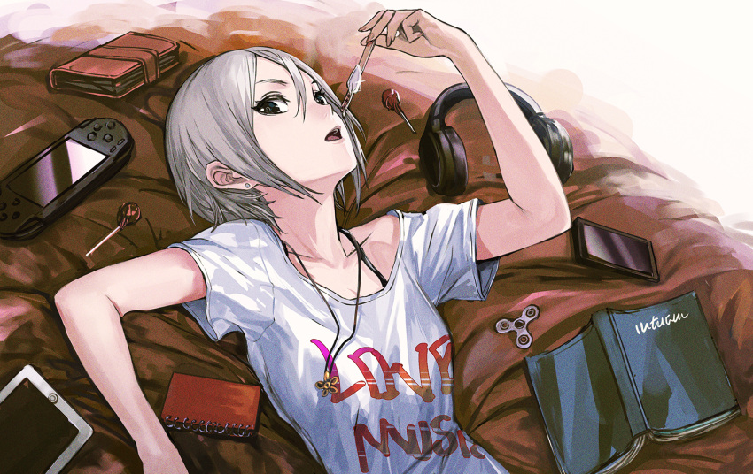 1girl, black_eyes, book, candy, cellphone, earrings, fidget_spinner, food