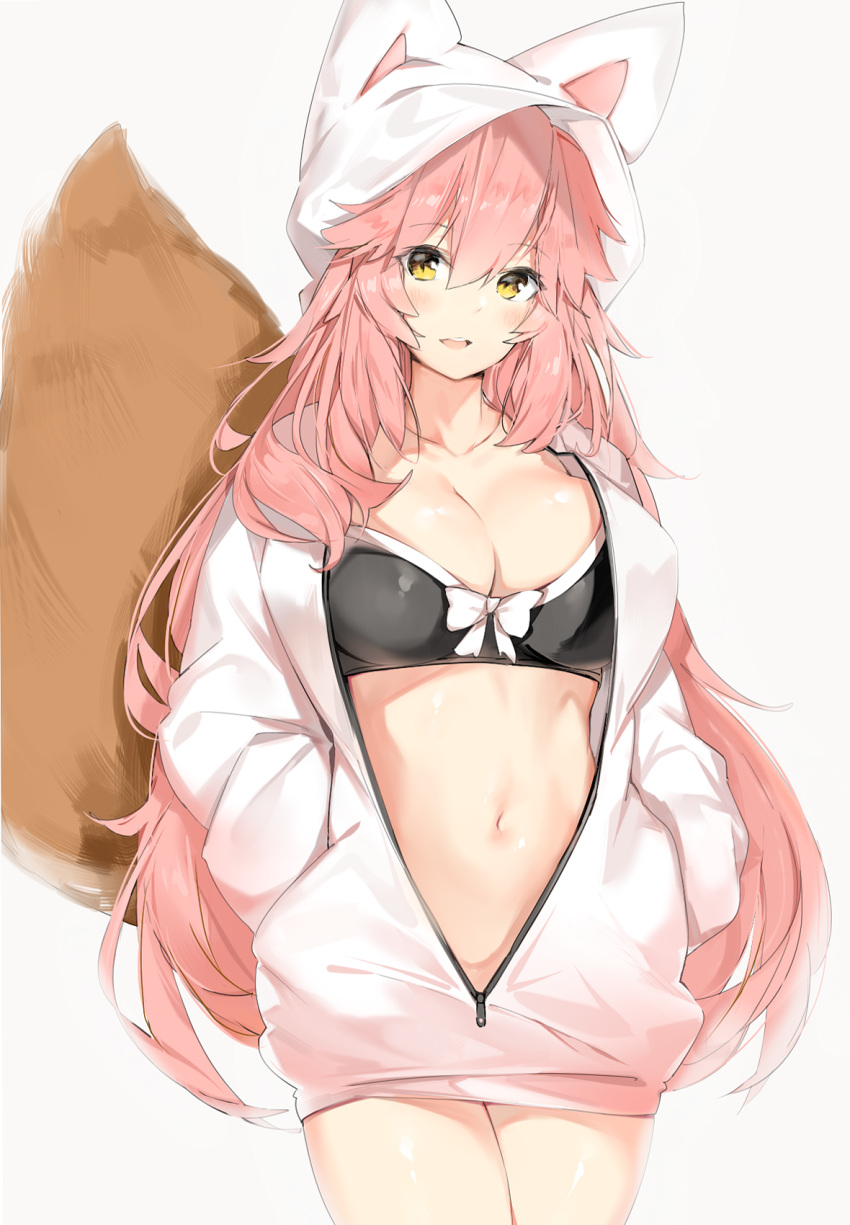 1girl, :d, animal_ears, animal_hood, bangs, bikini_top, black_bikini_top, blush, bow, bow_bikini, breasts, cleavage, collarbone, cowboy_shot, eyebrows_visible_through_hair, fate/extra, fate/grand_order, fate_(series), fox_ears, fox_girl, fox_hood, fox_tail, grey_background, hair_between_eyes, hands_in_pockets, head_tilt, highres, hood, hood_up, hoodie, large_breasts, long_hair, long_sleeves, looking_at_viewer, navel, open_clothes, open_hoodie, open_mouth, partially_unzipped, pink_hair, silver_(chenwen), simple_background, smile, solo, standing, stomach, tail, tamamo_(fate)_(all), tamamo_no_mae_(fate), tareme, unzipped, upper_teeth, very_long_hair, white_bow, white_hoodie, yellow_eyes, zipper