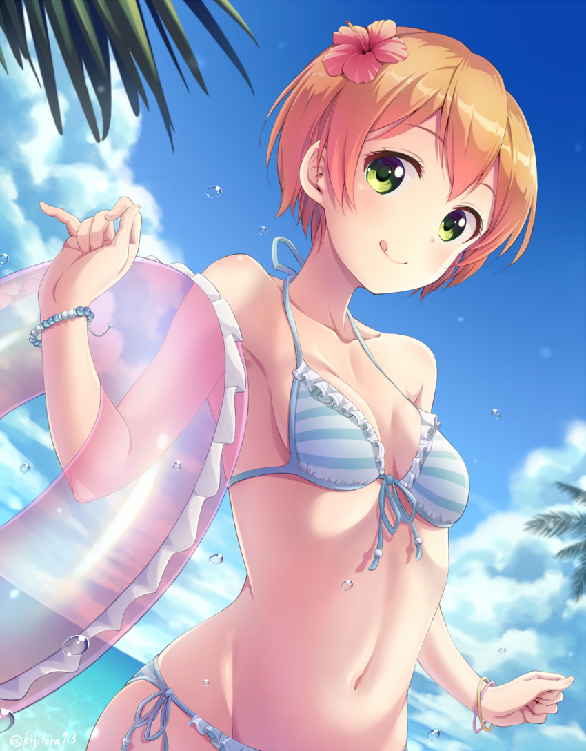 1girl, :q, bangs, bare_arms, bare_shoulders, bikini, blue_bikini, blue_ribbon, blue_sky, blush, bracelet, breasts, breasts_apart, clouds, collarbone, commentary, day, dutch_angle, english_commentary, eyebrows_visible_through_hair, flower, frilled_bikini, frills, front-tie_bikini, front-tie_top, green_eyes, hair_flower, hair_ornament, hibiscus, highres, hoshizora_rin, innertube, jewelry, looking_at_viewer, love_live!, love_live!_school_idol_project, navel, ocean, orange_hair, outdoors, palm_tree, pearl_bracelet, ribbon, sasurai_(kijitora713), shiny, shiny_hair, short_hair, side-tie_bikini, sky, small_breasts, solo, striped, striped_bikini, swimsuit, tongue, tongue_out, transparent, tree, twitter_username, upper_body, water, water_drop