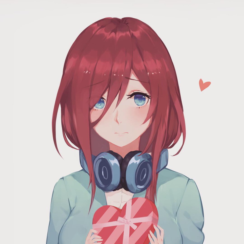 1girl, blue_cardigan, blue_eyes, blush, brown_hair, chocolate, chocolate_heart, closed_mouth