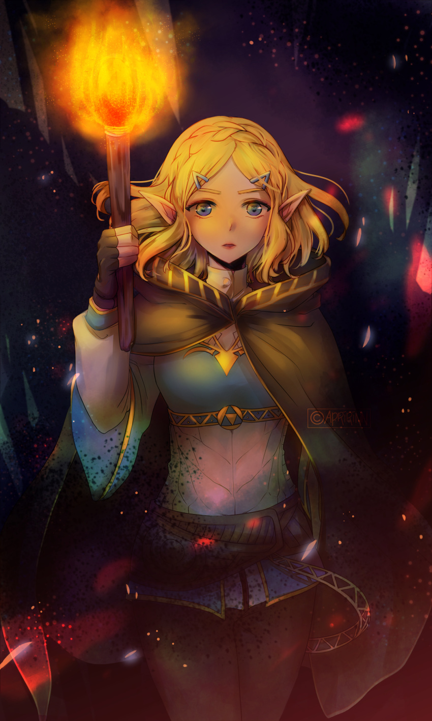 1girl, absurdres, apririnn, bangs, blonde_hair, blue_eyes, braid, cape, cloak, commentary_request, crown_braid, dark_background, fingerless_gloves, fire, gloves, hair_ornament, hairclip, highres, holding, holding_torch, long_sleeves, looking_at_viewer, parted_bangs, pointy_ears, princess_zelda, short_hair, solo, the_legend_of_zelda, the_legend_of_zelda:_breath_of_the_wild_2, thick_eyebrows, torch