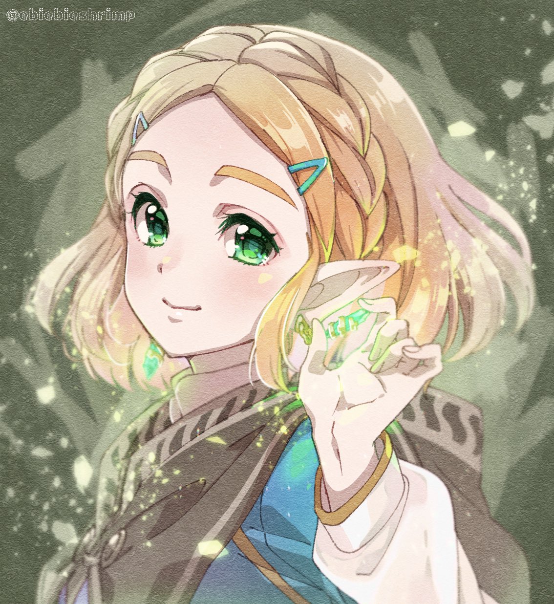 1girl, blonde_hair, blush, braid, brown_cape, cape, closed_mouth, colored_eyelashes, crown_braid, emerald_(gemstone), forehead, glowing, green_eyes, hair_ornament, hairclip, hand_up, highres, holding, holding_gemstone, hood, hood_down, hooded_cape, long_sleeves, looking_at_viewer, pointy_ears, princess_zelda, short_hair, shuri_(84k), sidelocks, smile, solo, the_legend_of_zelda, the_legend_of_zelda:_breath_of_the_wild, the_legend_of_zelda:_breath_of_the_wild_2, thick_eyebrows, upper_body