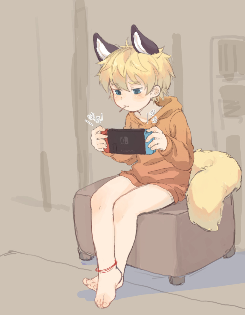 1boy, absurdres, animal_ears, barefoot, blonde_hair, blue_eyes, chinese_text, fox_boy, fox_ears, fox_tail, game_console, handheld_game_console, highres, hood, hoodie, indoors, male_focus, nintendo, nintendo_switch, original, playing_games, shotac0n, sitting, solo, tail