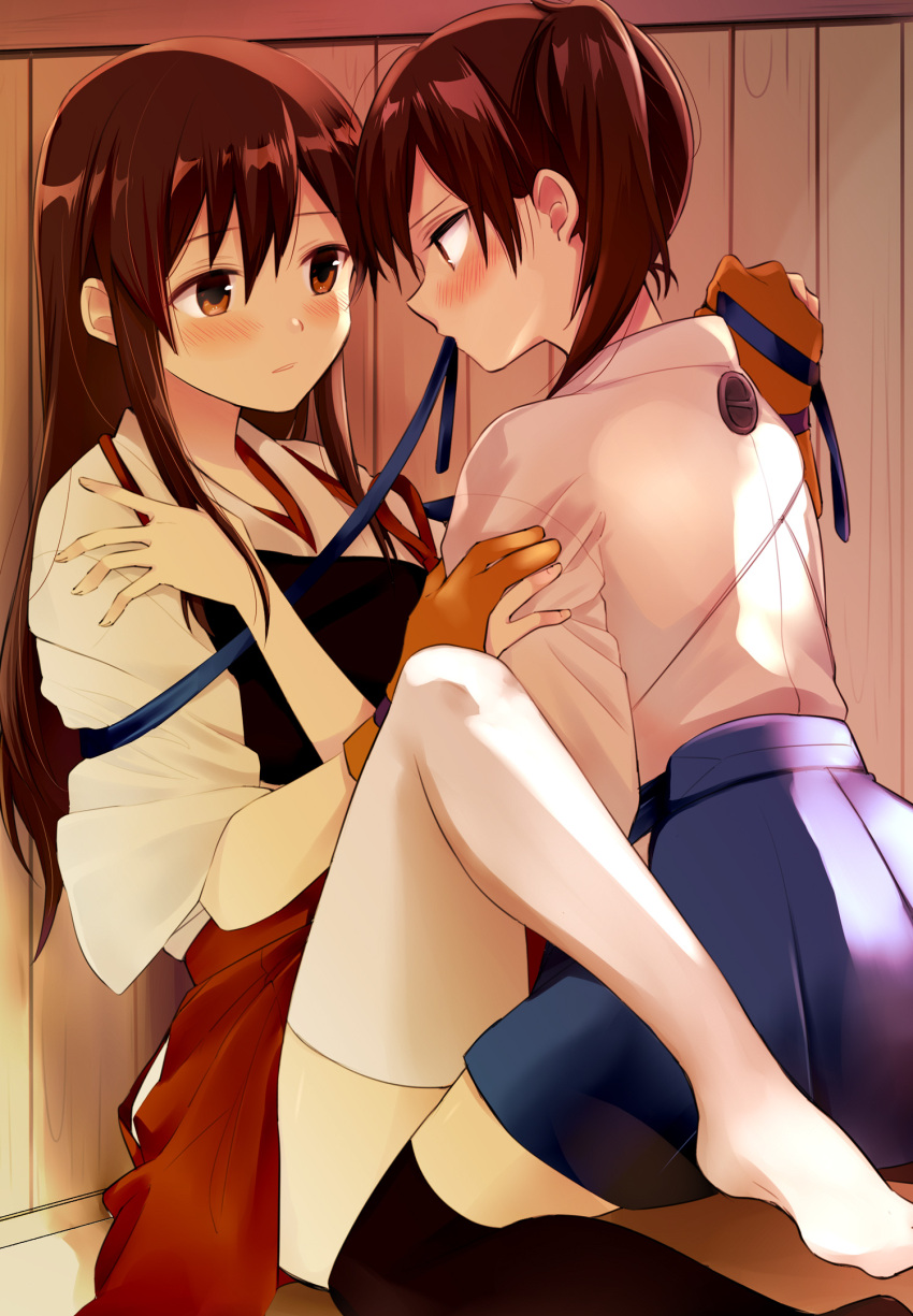 2girls, akagi_(kantai_collection), azumada, black_legwear, blue_hakama, blue_skirt, blush, brown_eyes, brown_hair, gloves, hakama, hakama_skirt, highres, japanese_clothes, kaga_(kantai_collection), kantai_collection, long_hair, long_sleeves, looking_at_another, multiple_girls, muneate, no_shoes, partly_fingerless_gloves, red_hakama, red_skirt, side_ponytail, single_glove, skirt, straight_hair, tasuki, thigh-highs, white_legwear, yugake, yuri