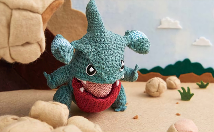 amigurumi_(medium), asako_ito, commentary, creature, english_commentary, full_body, gen_4_pokemon, gible, multiple_sources, no_humans, official_art, photo, pokemon, pokemon_(creature), pokemon_trading_card_game, solo, third-party_source