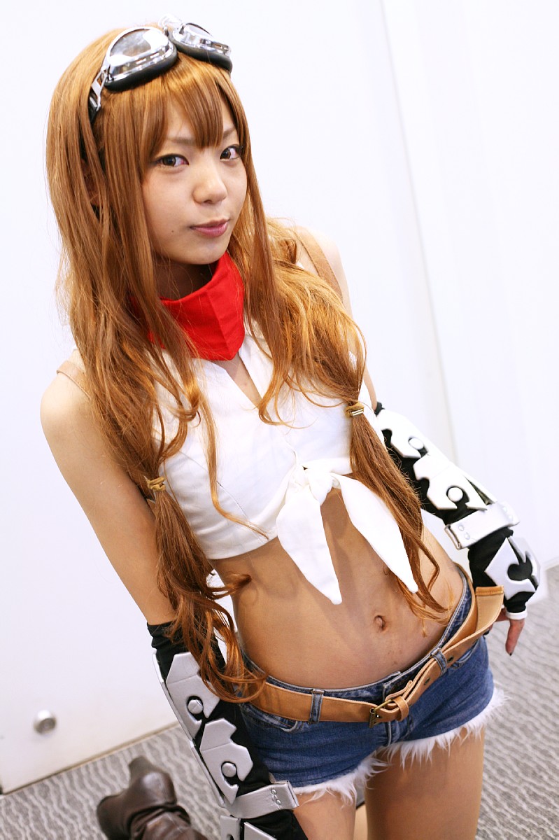 blonde_hair, boots, cosplay, denim, fingerless_elbow_gloves, goggles, midriff, photo