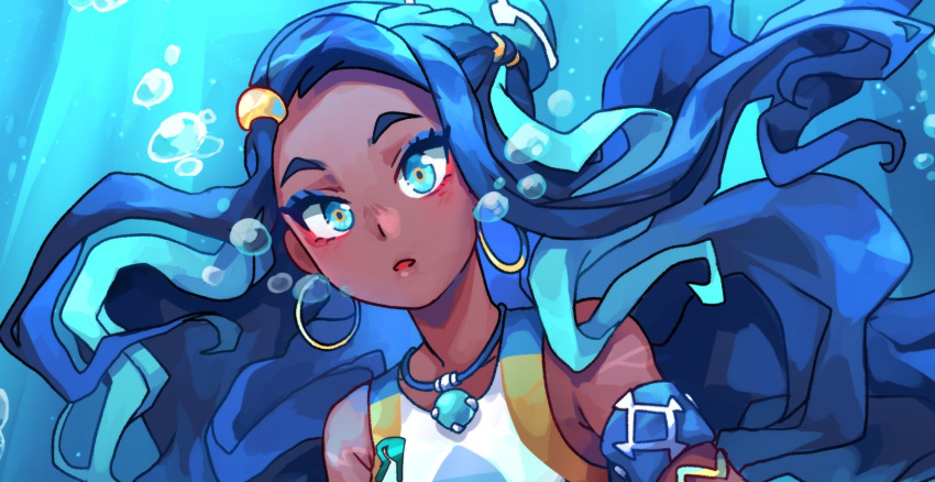1girl, :o, air_bubble, akuo, aqua_eyes, aqua_hair, armband, armlet, bare_shoulders, blue_background, blue_eyes, blue_eyeshadow, blue_hair, bubble, commentary, dark_skin, earrings, english_commentary, eyeliner, eyeshadow, gloves, gym_leader, hair_bun, highres, hoop_earrings, jewelry, long_hair, looking_at_viewer, makeup, multicolored_hair, necklace, nessa_(pokemon), open_mouth, parted_lips, pokemon, pokemon_(game), pokemon_swsh, raised_eyebrows, simple_background, solo, submerged, two-tone_hair, underwater