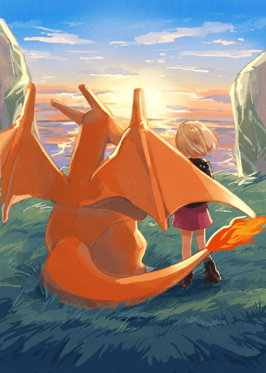 1girl, blonde_hair, boots, brown_footwear, charizard, clouds, day, dress, fire, flame, from_behind, gen_1_pokemon, grass, highres, jacket, mo~zu, outdoors, pokemon, pokemon_(creature), purple_dress, shiny, shiny_hair, short_hair, sky, standing, sunset, symbol_commentary