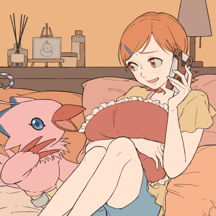 1girl, bangs, chunri_(cat795812), digimon, digimon_(creature), digimon_adventure, frilled_pillow, frills, green_shorts, hair_ornament, hairclip, highres, holding, indoors, knees_up, object_hug, open_mouth, orange_eyes, orange_hair, phone, pillow, piyomon, short_hair, short_sleeves, shorts, sitting, smile, takenouchi_sora