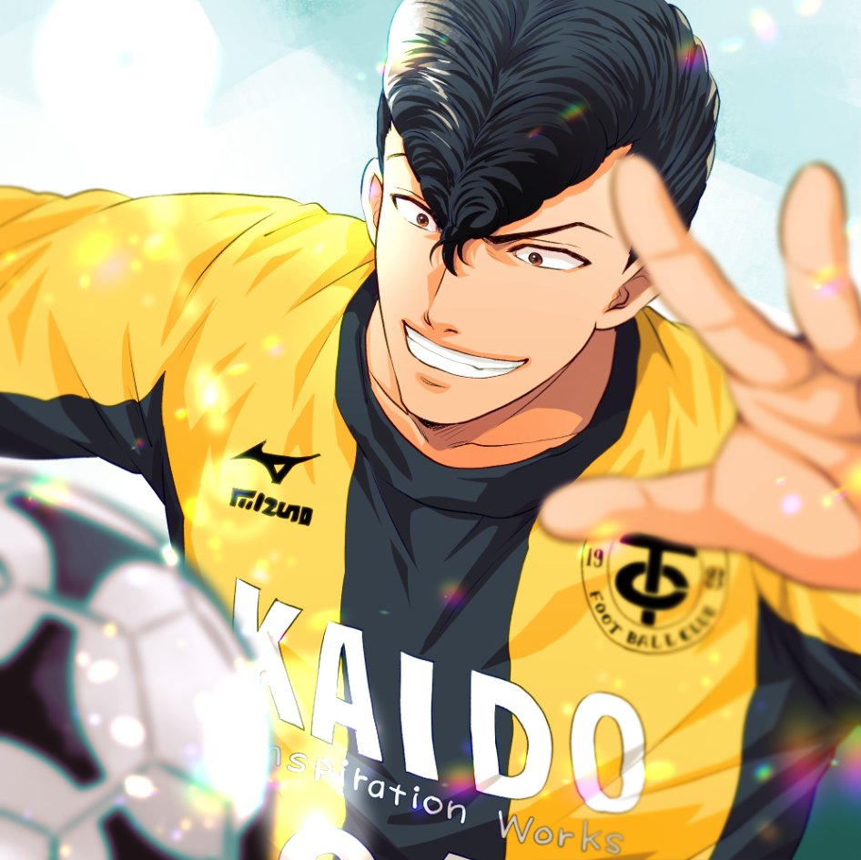 1boy, ao_ashi, ball, black_hair, blurry, blurry_foreground, brown_eyes, day, facing_viewer, grin, hand_up, ika_choco, jersey, male_focus, outdoors, pompadour, smile, soccer_ball, soccer_uniform, solo, sportswear, togashi_keiji, upper_body