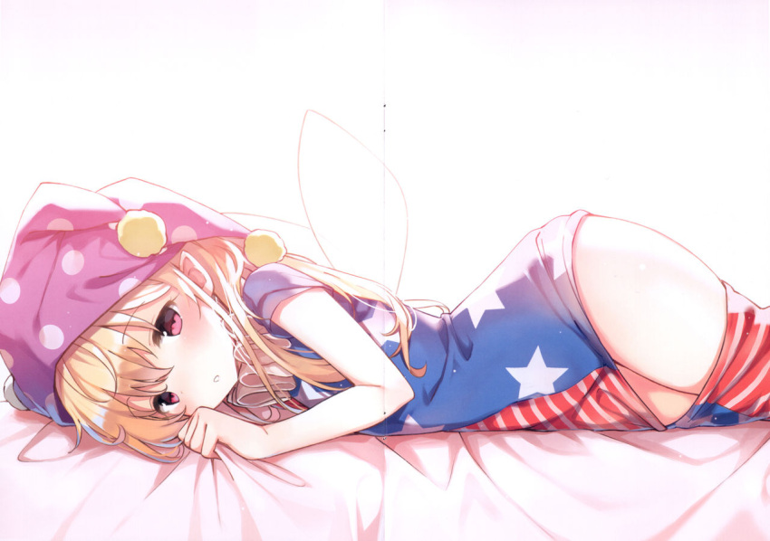 1girl, american_flag_pants, american_flag_shirt, bangs, bed, blonde_hair, blush, closed_mouth