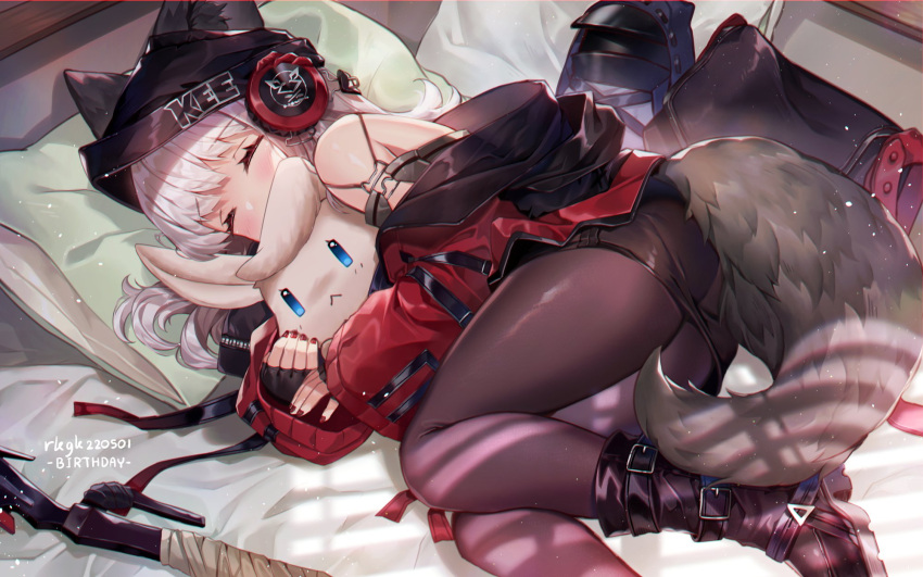 1girl, animal_ears, arknights, bangs, beanie, bed, birthday, black_legwear