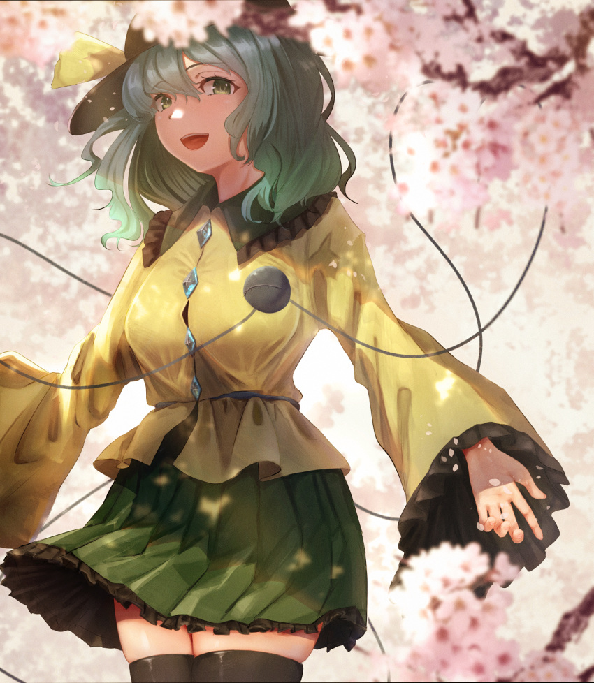 1girl, bangs, black_headwear, blurry, breasts, cherry_blossoms, collared_shirt, cowboy_shot, depth_of_field, eyebrows_visible_through_hair, eyelashes, frilled_shirt_collar, frilled_skirt, frilled_sleeves, frills, green_eyes, green_hair, green_skirt, hair_between_eyes, hat, hat_ribbon, heart, heart_of_string, highres, komeiji_koishi, long_sleeves, looking_at_viewer, medium_hair, open_mouth, outdoors, ribbon, shirt, skirt, smile, solo, string, thigh-highs, third_eye, touhou, tree, user_yumx3575, wide_sleeves, yellow_shirt