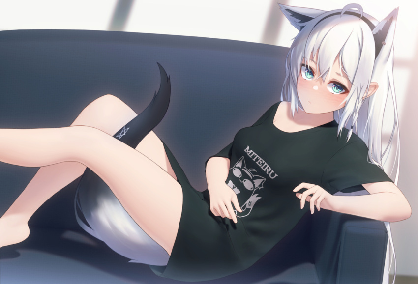 1girl, ahoge, animal_ears, bangs, bare_legs, between_legs, black_shirt, blurry, blurry_background, blush, braid, commentary_request, couch, earrings, extra_ears, eyebrows_visible_through_hair, fox_ears, fox_girl, fox_tail, green_eyes, hair_between_eyes, hairband, hololive, indoors, jewelry, knees_up, long_hair, looking_at_viewer, miteiru_(shirakami_fubuki), pentagram, shirai_yu, shirakami_fubuki, shirt, short_sleeves, sidelocks, single_braid, sitting, solo, tail, tail_between_legs, virtual_youtuber, white_hair
