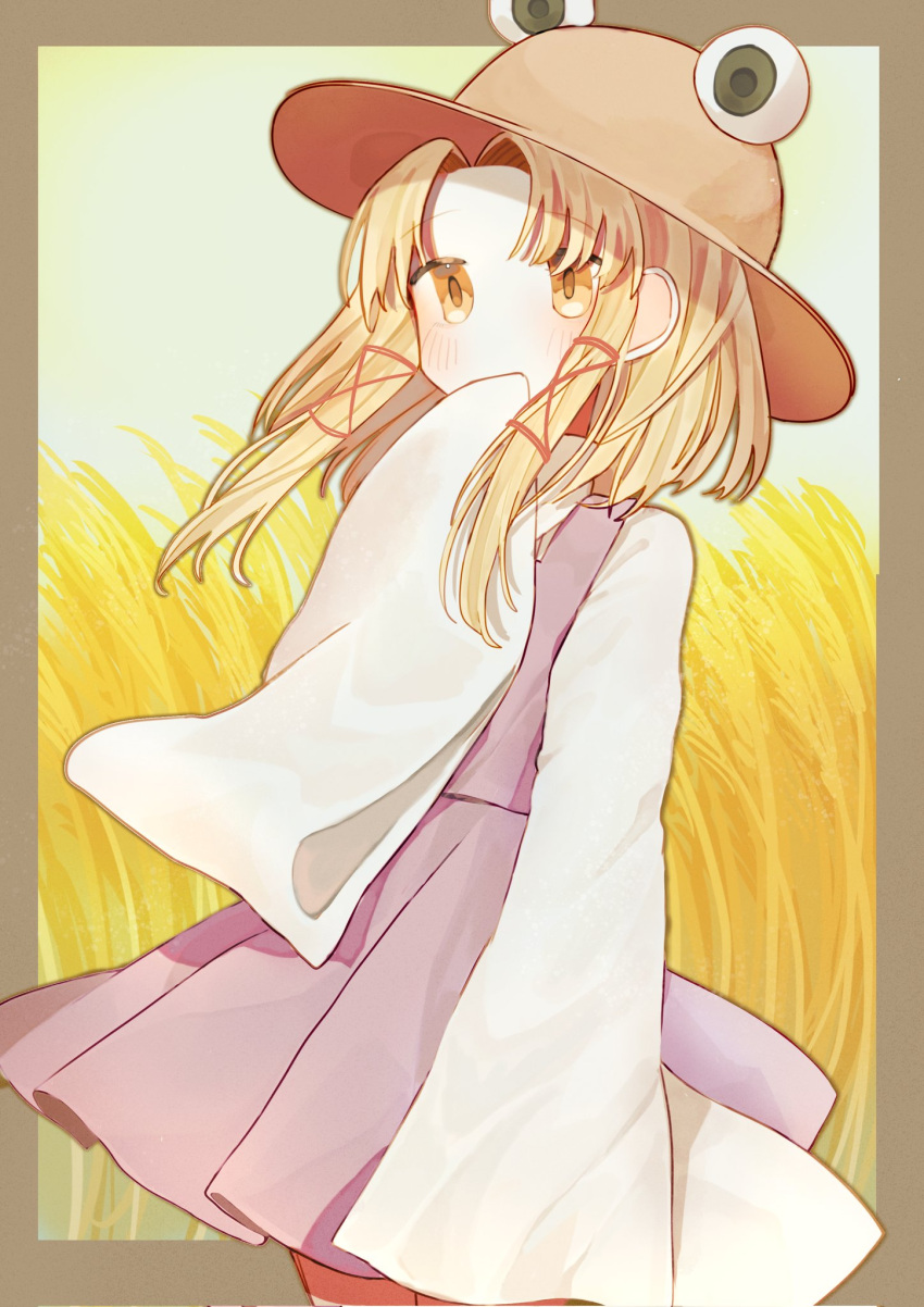 1girl, bangs, blonde_hair, blush, border, brown_border, brown_headwear, commentary, covered_mouth, feet_out_of_frame, hand_to_own_mouth, hat, highres, long_hair, long_sleeves, moriya_suwako, parted_bangs, purple_skirt, purple_vest, sidelocks, skirt, solo, symbol-only_commentary, touhou, turtleneck, vest, wheat_field, wide_sleeves, yellow_eyes, yuejinlin